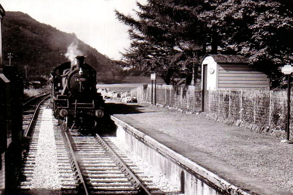 Black and white photograph of a steam train pulling into Kentallen Station